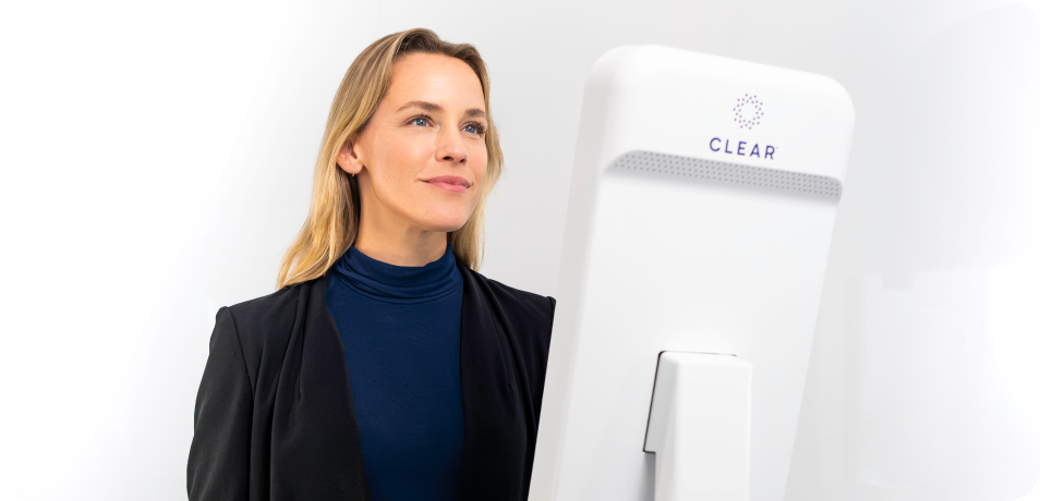 Woman verifying identity with CLEAR EnVe pod